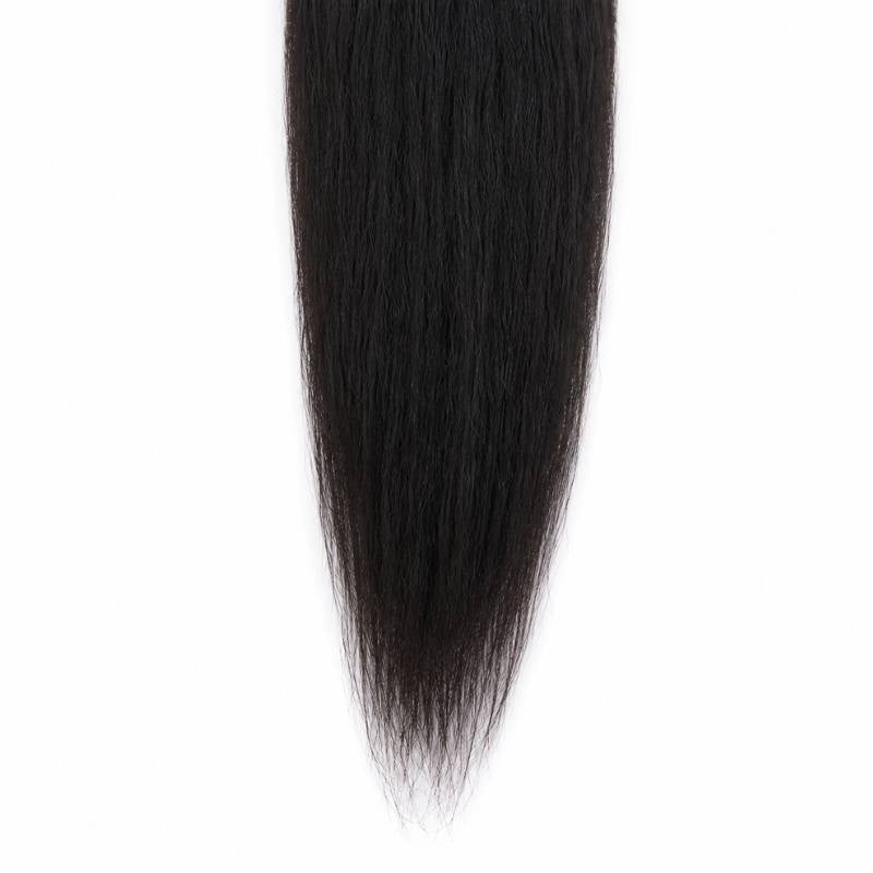 Close-up of the tapered ends of natural black kinky straight sew-in hair extensions narrowing to a point on a white background