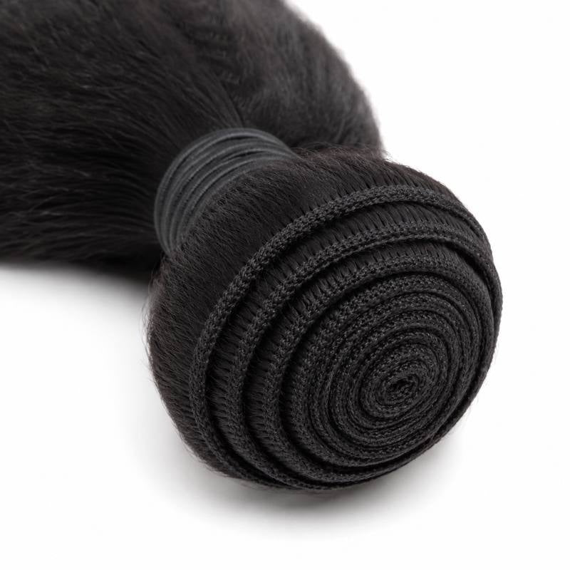 Macro view of the coiled weft on natural black kinky straight sew-in hair extensions showing the stitched track spiralling into the centre