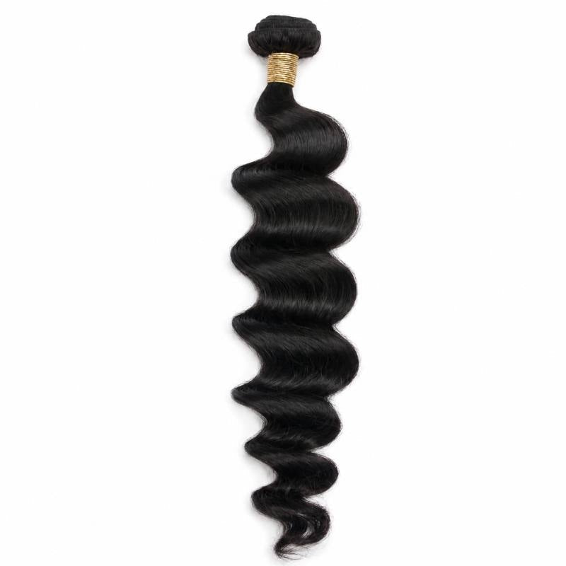 Single bundle of natural black loose wave sew-in hair extensions hanging on a white background with gold thread wrapped around the weft