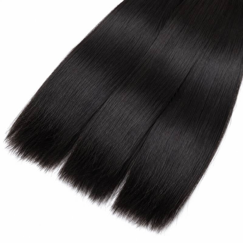 Close-up of the tapered ends of three bundles of natural black straight sew-in hair extensions against a white background