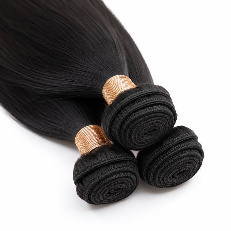 Close-up of the coiled stitched weft tops on three bundles of natural black straight sew-in hair extensions with gold thread wraps