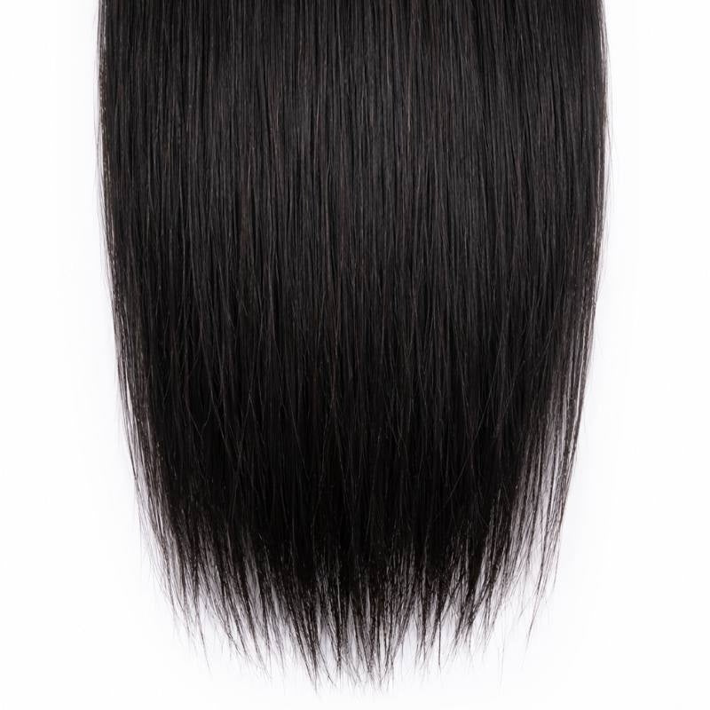 Close-up of the blunt cut ends of natural black straight sew-in hair extensions against a white background