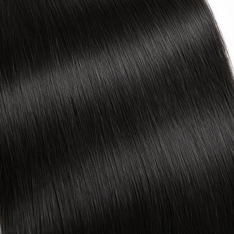 Full frame macro of natural black straight sew-in hair extensions showing smooth parallel strands and light reflecting along the shafts