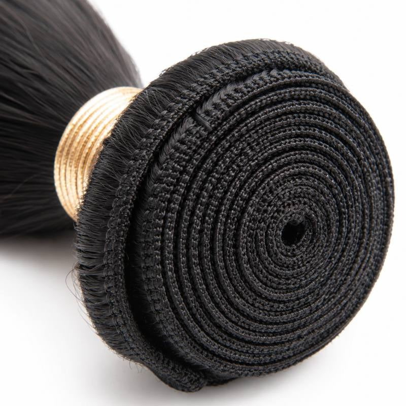 Macro close-up of the spiral coiled weft on natural black straight sew-in hair extensions showing the rows of machine stitching