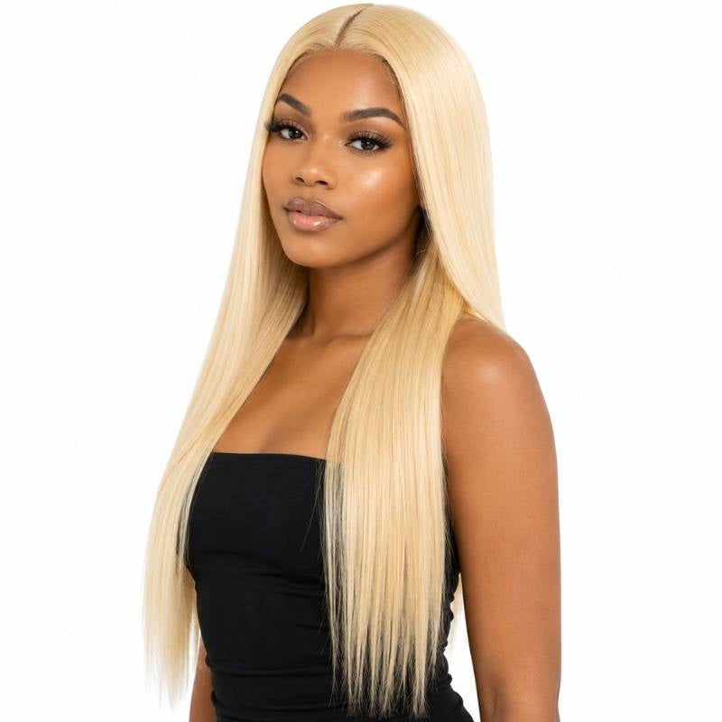 Model wearing long blonde straight sew-in hair extensions with a middle part over a black strapless top