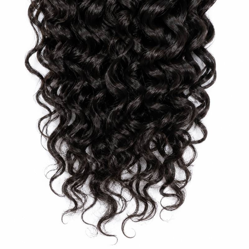 Close-up of the ends of natural black curly sew-in hair extensions showing spiral curls tapering into the tips on a white background
