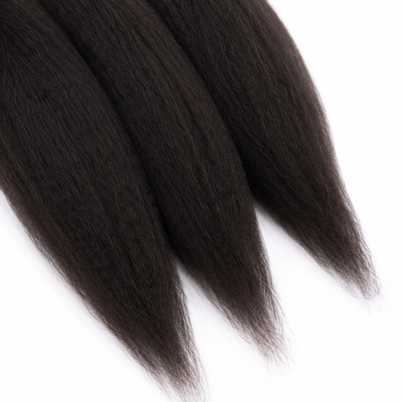 Close-up of the tapered ends of three bundles of natural black kinky straight sew-in hair extensions against a white background