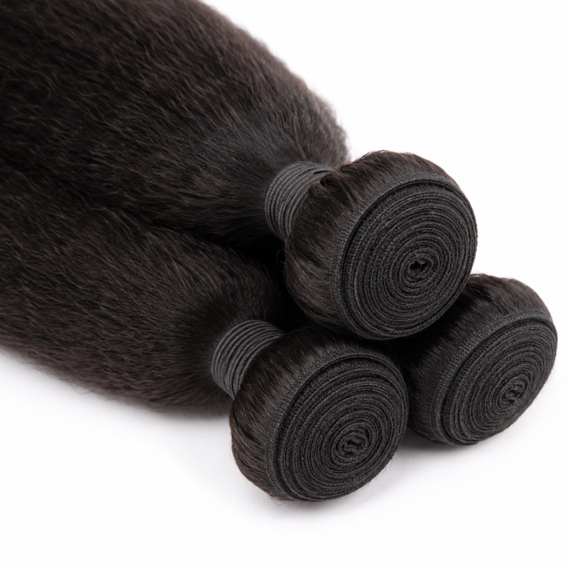 Close-up of the coiled wefts on three bundles of natural black kinky straight sew-in hair extensions bound with dark thread