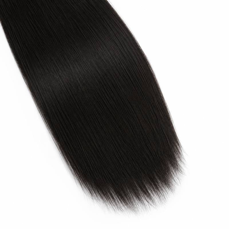 Close-up of the ends of natural black straight sew-in hair extensions tapering across a white background