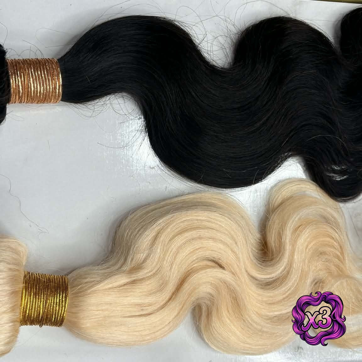 Flat lay of blonde 613 and natural black body wave sew-in hair extensions bundles with weft detail and wave texture comparison