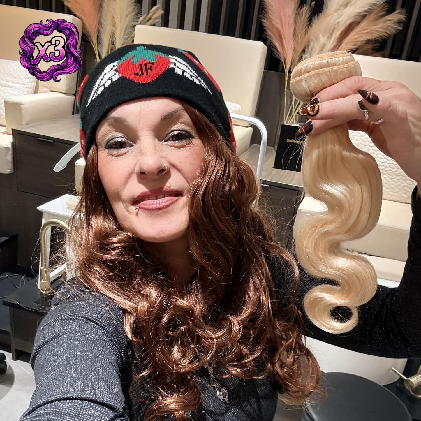 Model showcasing blonde 613 body wave sew-in hair extensions 3 bundle deal held at shoulder height in salon lounge area