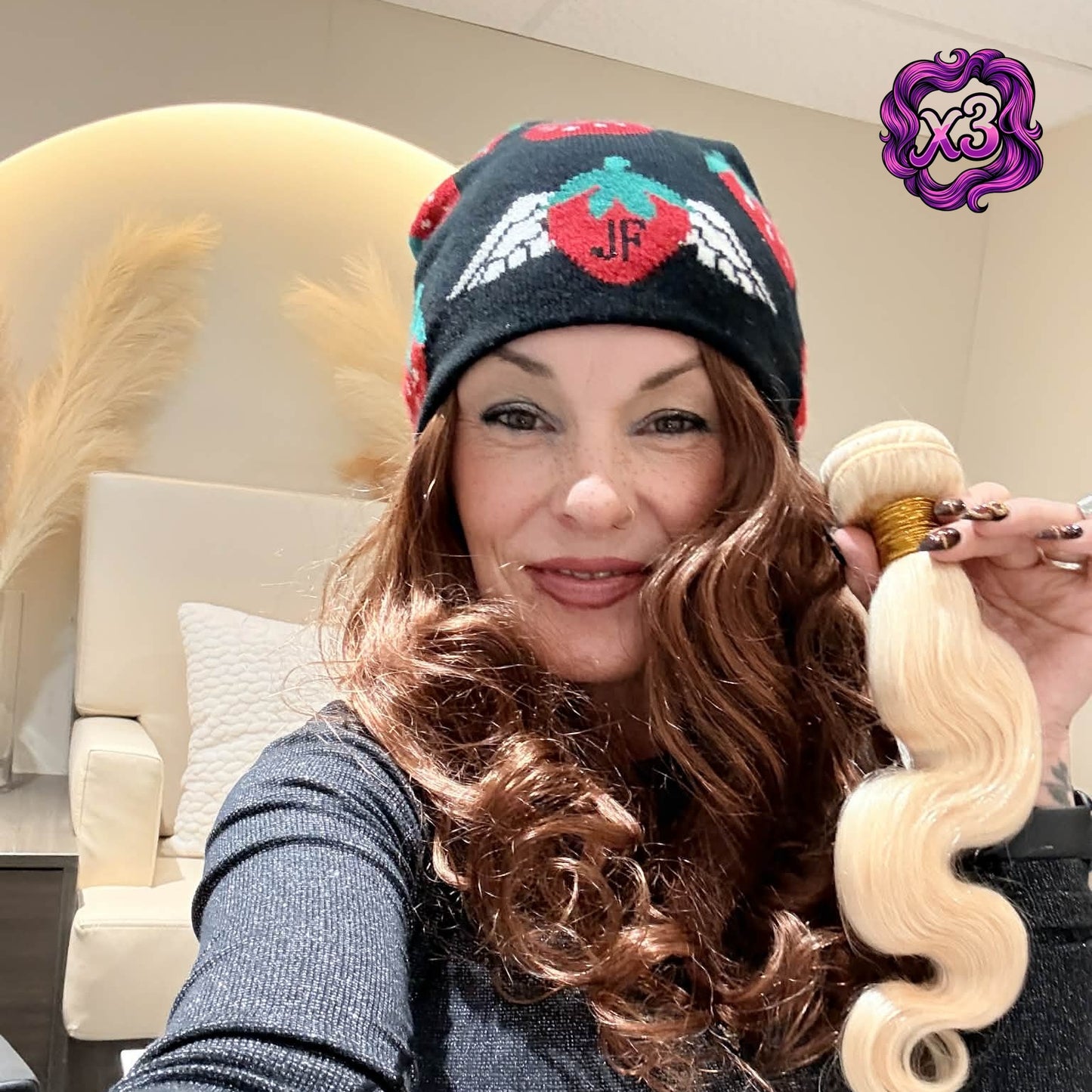 Model holding blonde 613 body wave sew-in hair extensions 3 bundle deal showing wave pattern and bundle thickness in salon