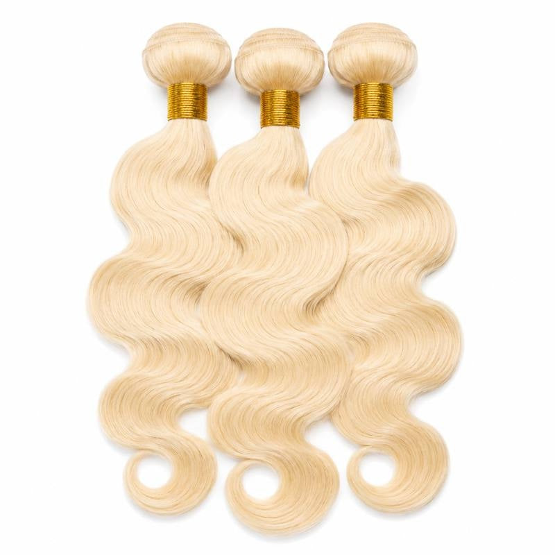 Three bundles of blonde body wave sew-in hair extensions overlapping on a white background with gold thread bound wefts