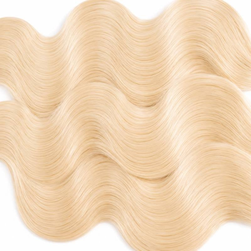 Macro view of blonde body wave sew-in hair extensions showing the even S wave pattern running across the frame