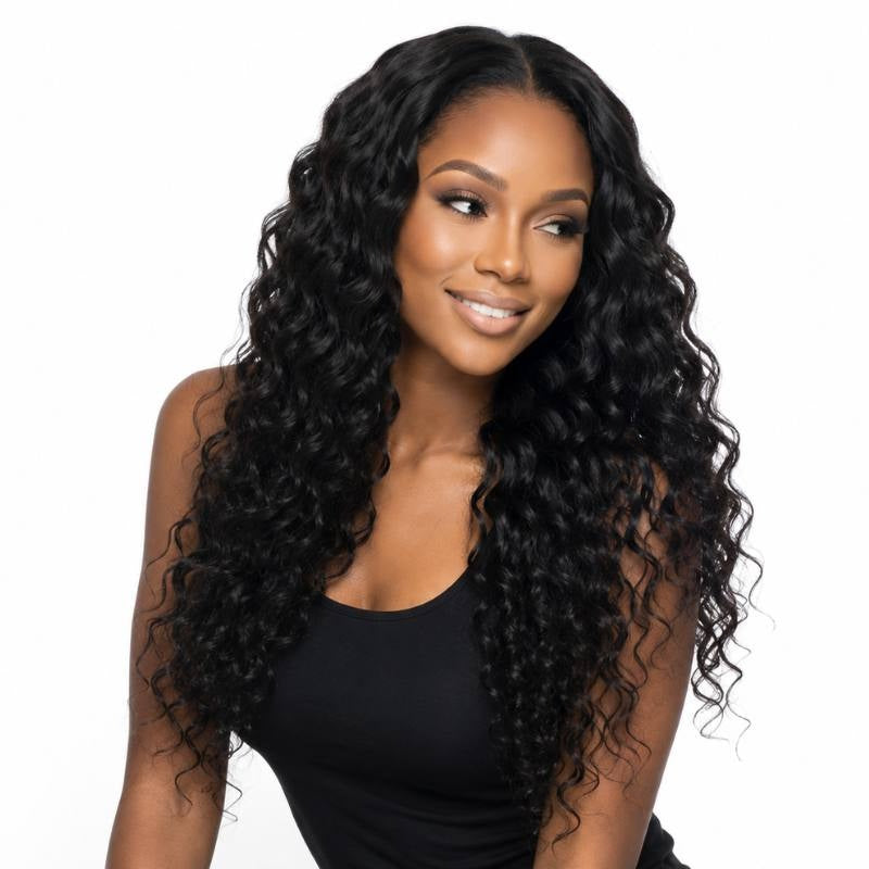 Model looking to the side on a white background wearing natural black sew-in hair extensions in a defined wave pattern with a middle part