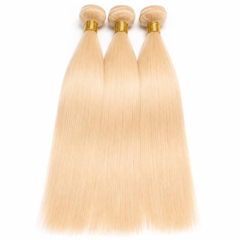 Three bundles of blonde straight sew-in hair extensions overlapping on a white background with gold thread wrapped wefts