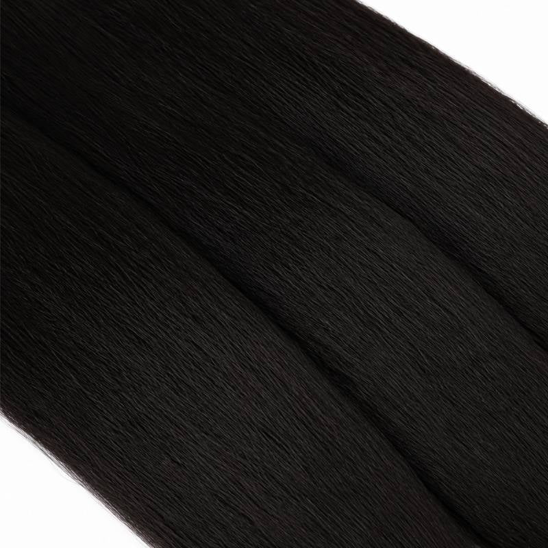 Macro view of natural black yaki straight sew-in hair extensions showing the coarse straight strand texture and soft sheen