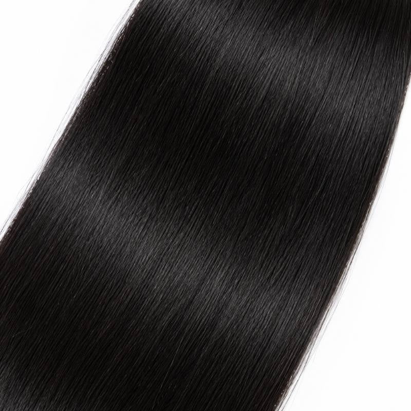 Close-up of the mid length of natural black yaki straight sew-in hair extensions showing smooth strands and a reflected highlight