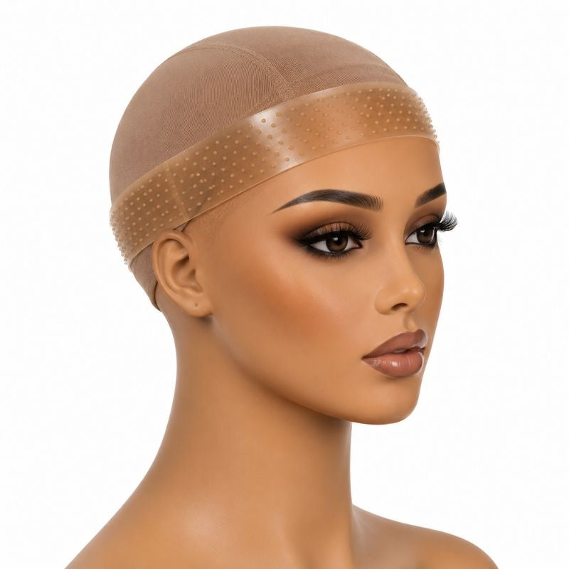 Tan silicone wig grip band worn over a nude wig cap on a mannequin head, used to hold wigs and hair extensions steady