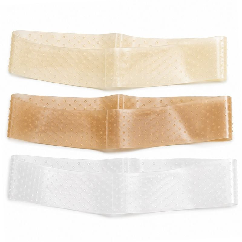 Three silicone wig grip bands in clear, beige and tan laid flat, a dotted band accessory used with wigs and hair extensions