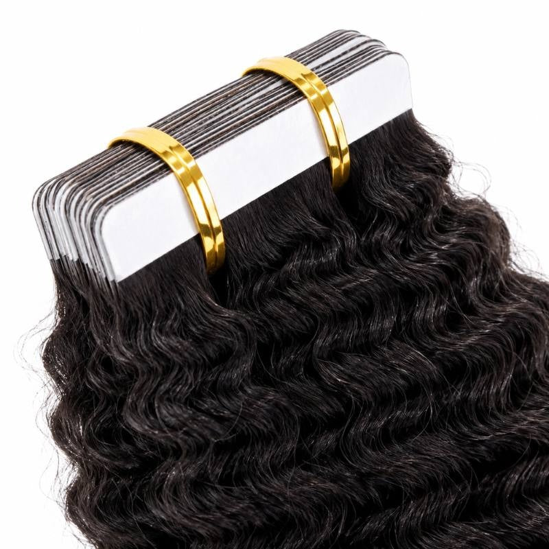 Macro view of the white adhesive tape tabs on natural black kinky curly tape-in hair extensions bound in a stack